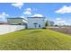View of the backyard featuring a spacious, well-maintained lawn, perfect for outdoor activities and relaxation at 313 Argyll Dr, Spring Hill, FL 34609