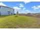 The expansive backyard offers a generous lawn space, presenting opportunities for various outdoor activities and landscaping at 313 Argyll Dr, Spring Hill, FL 34609