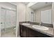 Bathroom featuring double sink vanity with granite countertops and a shower at 313 Argyll Dr, Spring Hill, FL 34609