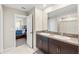 Well-lit bathroom featuring a double sink vanity and connecting bedroom at 313 Argyll Dr, Spring Hill, FL 34609