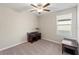 Bright bedroom features neutral walls, ceiling fan and window with adjustable blinds at 313 Argyll Dr, Spring Hill, FL 34609