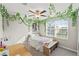 Bright bedroom enhanced by decorative hanging vines, and natural light from window with blinds at 313 Argyll Dr, Spring Hill, FL 34609