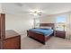 Spacious bedroom featuring a ceiling fan, carpeted floor, and natural light at 313 Argyll Dr, Spring Hill, FL 34609