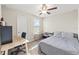 Neutral bedroom with ceiling fan, desk, and carpeted floor at 313 Argyll Dr, Spring Hill, FL 34609