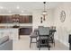 A dining area featuring modern pendant lighting, decorative wall pieces, and neutral wall paint at 313 Argyll Dr, Spring Hill, FL 34609