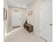 Bright entryway with tile flooring, storage bench, and decorative wall art for a welcoming feel at 313 Argyll Dr, Spring Hill, FL 34609