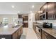 Modern kitchen features granite countertops, stainless steel appliances, and dark wood cabinetry at 313 Argyll Dr, Spring Hill, FL 34609