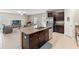 Open-concept kitchen with a center island, stainless steel appliances, and dark wood cabinets at 313 Argyll Dr, Spring Hill, FL 34609