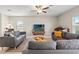Comfortable living room featuring a sectional sofa, neutral walls, and a seamless connection to the dining area at 313 Argyll Dr, Spring Hill, FL 34609