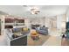 Spacious living room with a gray sofa set, a decorative rug, and seamless flow into kitchen and dining areas at 313 Argyll Dr, Spring Hill, FL 34609