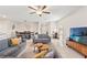Cozy living room with a large sofa, natural light, and seamless connection to the dining area at 313 Argyll Dr, Spring Hill, FL 34609