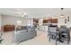 Bright, open-concept living area with a comfortable seating arrangement and views of the kitchen and dining area at 313 Argyll Dr, Spring Hill, FL 34609