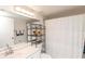Clean bathroom featuring a shower with a patterned curtain and chrome accents at 3153 Lake Pine Way # A1, Tarpon Springs, FL 34688