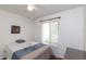 Bright bedroom with a ceiling fan, natural light, and a minimalist design at 3153 Lake Pine Way # A1, Tarpon Springs, FL 34688