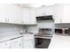 Well-maintained kitchen featuring white cabinets, stainless steel appliances, and updated countertops at 3153 Lake Pine Way # A1, Tarpon Springs, FL 34688