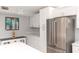 Kitchen with white cabinets, stainless steel refrigerator, and updated countertops at 3153 Lake Pine Way # A1, Tarpon Springs, FL 34688