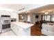 Open-concept kitchen featuring stainless appliances, white cabinets, and breakfast bar at 3153 Lake Pine Way # A1, Tarpon Springs, FL 34688