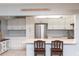 Beautiful kitchen featuring white cabinetry, stainless appliances, and breakfast bar at 3153 Lake Pine Way # A1, Tarpon Springs, FL 34688
