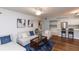 Comfortable living room with hardwood floors and an open view into the kitchen at 3153 Lake Pine Way # A1, Tarpon Springs, FL 34688