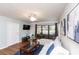 Comfortable living room with ceiling fan, TV, and glass doors leading to the lanai at 3153 Lake Pine Way # A1, Tarpon Springs, FL 34688
