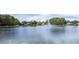 A large pond with a fountain creates a serene view in this peaceful community at 3153 Lake Pine Way # A1, Tarpon Springs, FL 34688