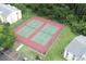 An aerial view showcases two well-maintained tennis courts next to the condo building at 3153 Lake Pine Way # A1, Tarpon Springs, FL 34688