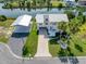 Aerial view of a two-story home with covered parking, lush landscaping, and waterfront access at 3342 Turks Cap Dr, Hernando Beach, FL 34607