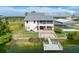 Waterfront home showcasing a private dock, hot tub, and detached carport at 3342 Turks Cap Dr, Hernando Beach, FL 34607