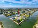 Aerial view of waterfront homes in a canal community, each with private boat docks and lush surroundings at 3342 Turks Cap Dr, Hernando Beach, FL 34607