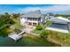 Waterfront home featuring a private dock, fenced in yard, and large carport at 3342 Turks Cap Dr, Hernando Beach, FL 34607