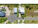 Aerial view of a waterfront property with a metal roof, dock, spacious yard, and convenient street access at 3342 Turks Cap Dr, Hernando Beach, FL 34607