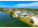 Aerial view of a waterfront home with a metal carport in a residential area with water views at 3342 Turks Cap Dr, Hernando Beach, FL 34607