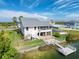 Waterfront house featuring an extended dock, fenced yard, detached carport and hot tub at 3342 Turks Cap Dr, Hernando Beach, FL 34607