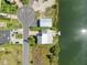 Waterfront home aerial view with a metal roof, adjacent to a cul-de-sac and a private dock on the water at 3342 Turks Cap Dr, Hernando Beach, FL 34607