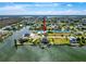 Stunning aerial view of waterfront home with private dock, lush landscaping, and access to open water at 3342 Turks Cap Dr, Hernando Beach, FL 34607