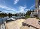 A backyard with a canal view features brick pavers, a concrete patio, and stairs to the home's second level at 3342 Turks Cap Dr, Hernando Beach, FL 34607