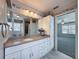 Stylish bathroom featuring vanity with granite countertop, ample storage and a view of the adjoining room at 3342 Turks Cap Dr, Hernando Beach, FL 34607