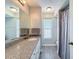Bathroom with a granite countertop, a large mirror, and vinyl flooring at 3342 Turks Cap Dr, Hernando Beach, FL 34607