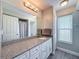 Bathroom with granite countertop, big mirror, vanity lights and shower at 3342 Turks Cap Dr, Hernando Beach, FL 34607