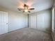 Bedroom with a ceiling fan, a closet and a door to another room at 3342 Turks Cap Dr, Hernando Beach, FL 34607