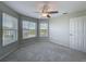 Corner bedroom featuring carpeted floors and multiple windows with views at 3342 Turks Cap Dr, Hernando Beach, FL 34607