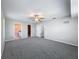 Spacious bedroom with neutral walls, ceiling fan, carpet flooring and doors to ensuite bathroom and walk-in closet at 3342 Turks Cap Dr, Hernando Beach, FL 34607
