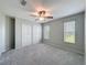 Bedroom with a ceiling fan, two windows, and a double-door closet at 3342 Turks Cap Dr, Hernando Beach, FL 34607