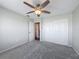 Bedroom with neutral colored walls, carpet, fan, and an ensuite bath at 3342 Turks Cap Dr, Hernando Beach, FL 34607