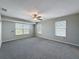 Spacious bedroom with neutral walls, plush carpet and double-paned windows at 3342 Turks Cap Dr, Hernando Beach, FL 34607