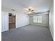 Cozy bedroom featuring a ceiling fan, neutral walls, carpet flooring and a doorway to the rest of the house at 3342 Turks Cap Dr, Hernando Beach, FL 34607