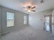 Neutral bedroom featuring a ceiling fan and two windows with blinds at 3342 Turks Cap Dr, Hernando Beach, FL 34607