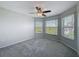 Corner bedroom featuring carpeted floors and multiple windows at 3342 Turks Cap Dr, Hernando Beach, FL 34607