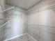 Walk-in closet featuring wire shelving and hardwood floors at 3342 Turks Cap Dr, Hernando Beach, FL 34607