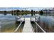 Canal-front dock with bench seating offers stunning waterfront views of the neighborhood at 3342 Turks Cap Dr, Hernando Beach, FL 34607